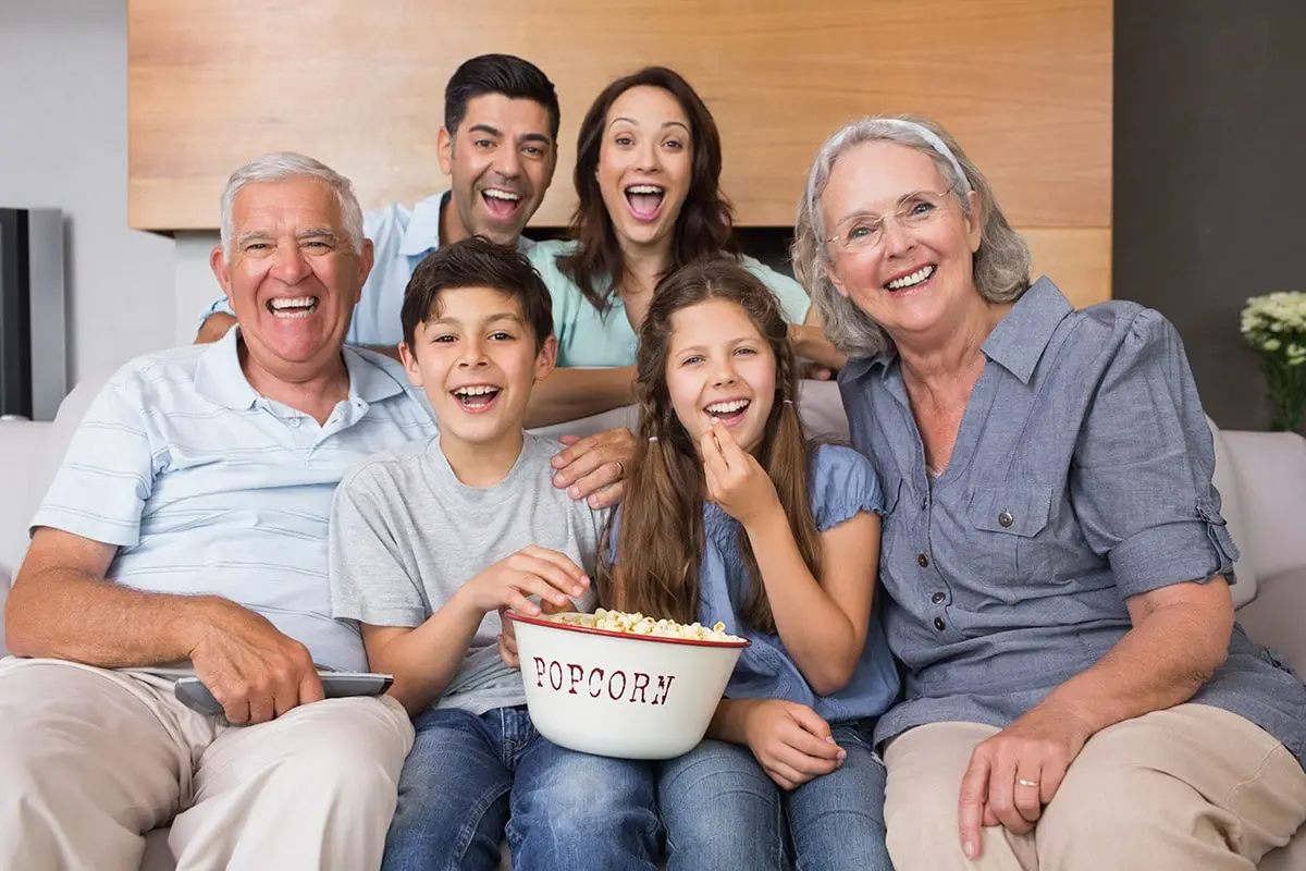 Family of several generations watching TV together in an Ontario living room
